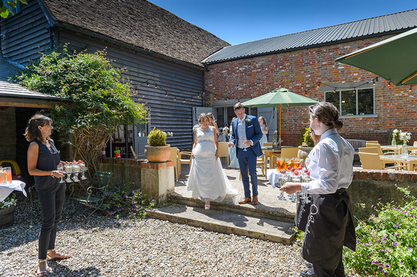 Wedding couple greeted by drinks at reception