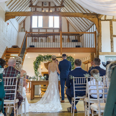 Looking up the aisle of a wedding ceremony towards Bride and Groom